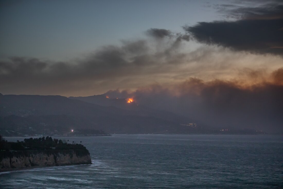 Smoke from the Palisades Fire is seen from Point Dume while it burns homes along the Pacific Coast Highway amid a powerful windstorm on January 8, 2025 in Malibu, California. Fueled by intense Santa Ana Winds, the Palisades Fire has burned through thousands of acres while a second major fire continues to burn near Eaton Canyon in Altadena.